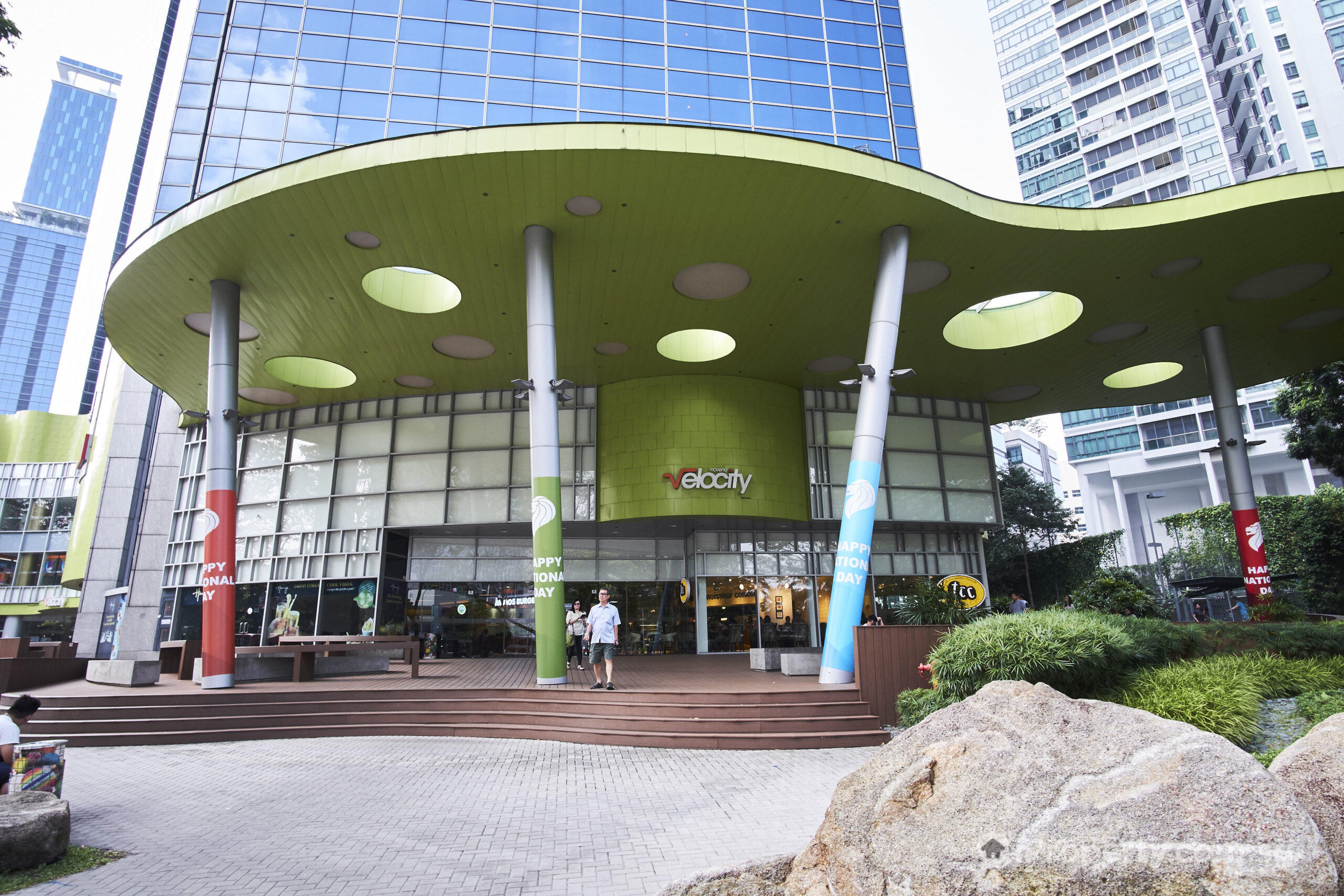 Exterior view of Velocity @ Novena Square with signs of various food outlets visible, emphasizing its role as a dining and sports destination.