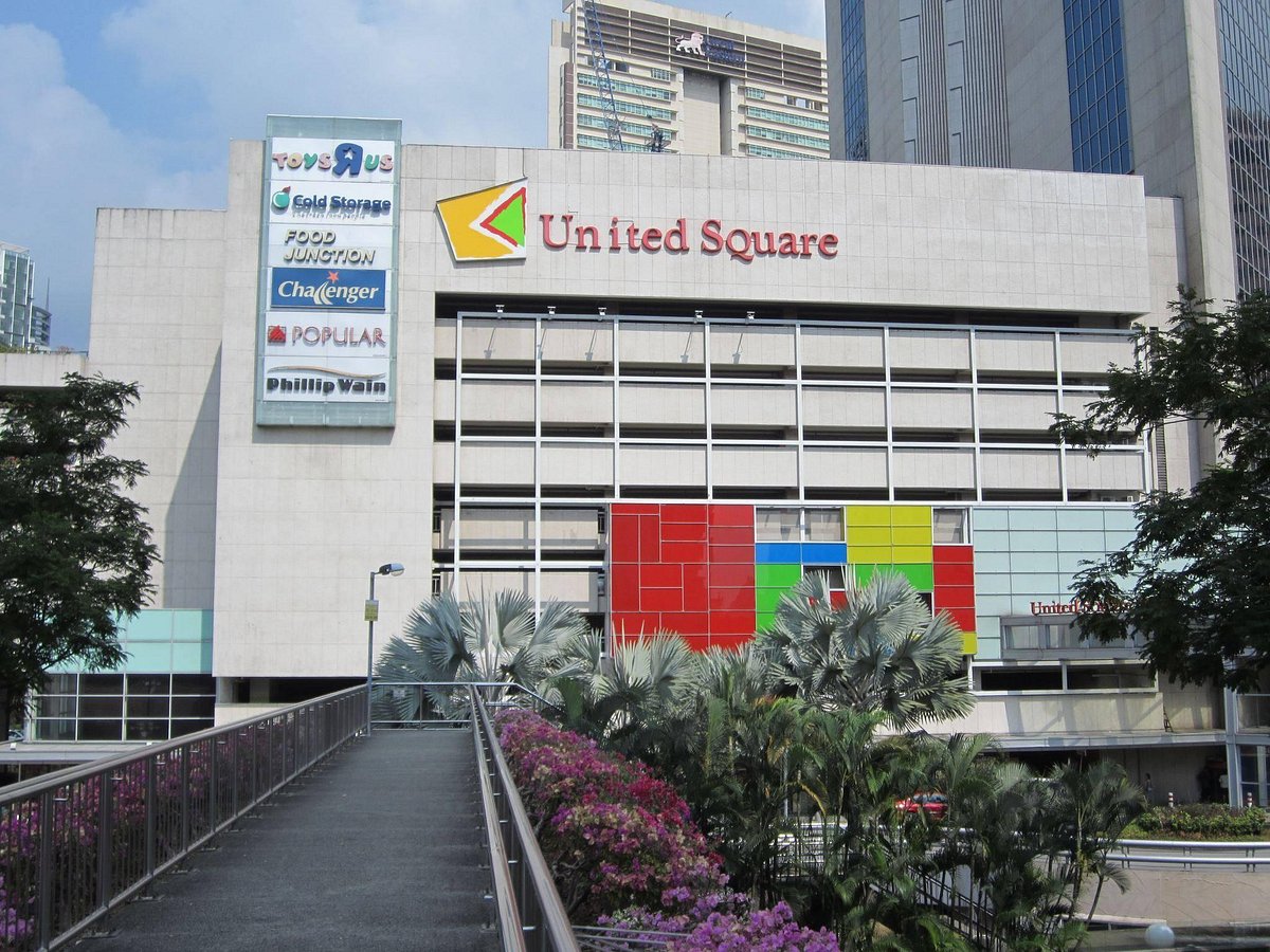 Image of United Square's vibrant entrance with visible signs of diverse dining options, showcasing its appeal as a family and food destination.